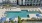 resort style pool with loungers and building in the background