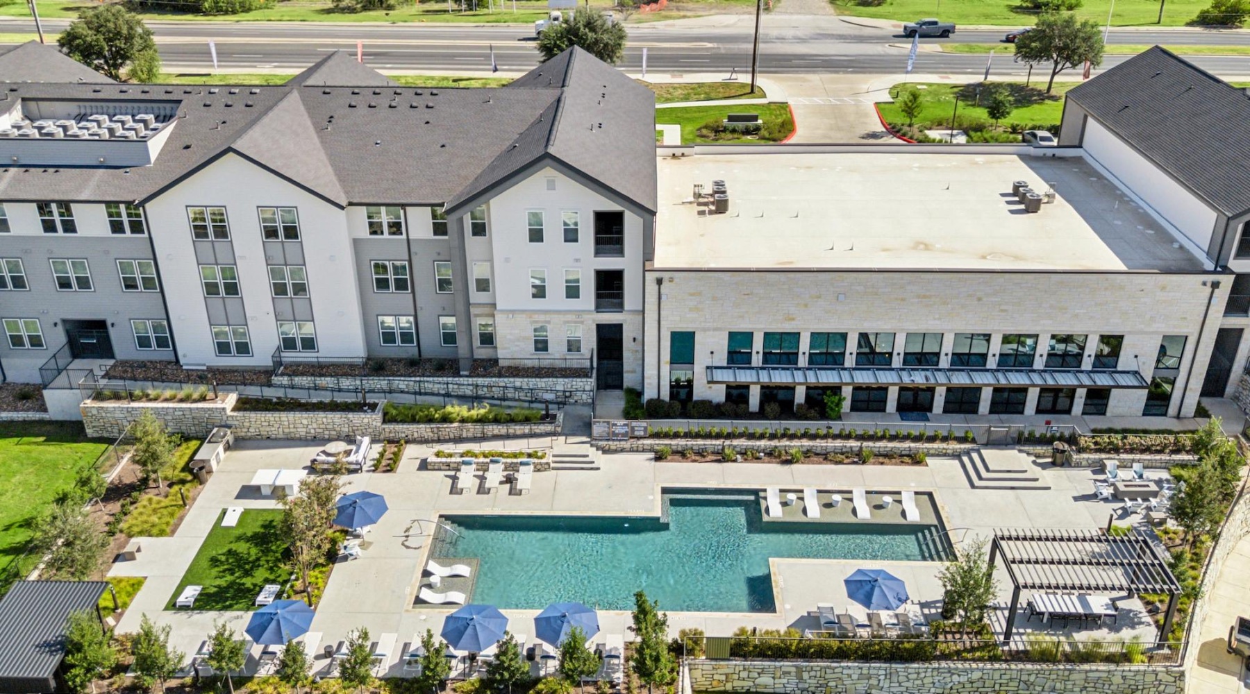 an overview of a multi story building and courtyard with a pool