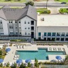 an overview of a multi story building and courtyard with a pool