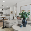 a living room with a wood floor a couch and a dining table