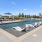 resort style pool with loungers and building in the background