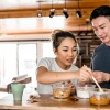 young couple eat at a standing table
